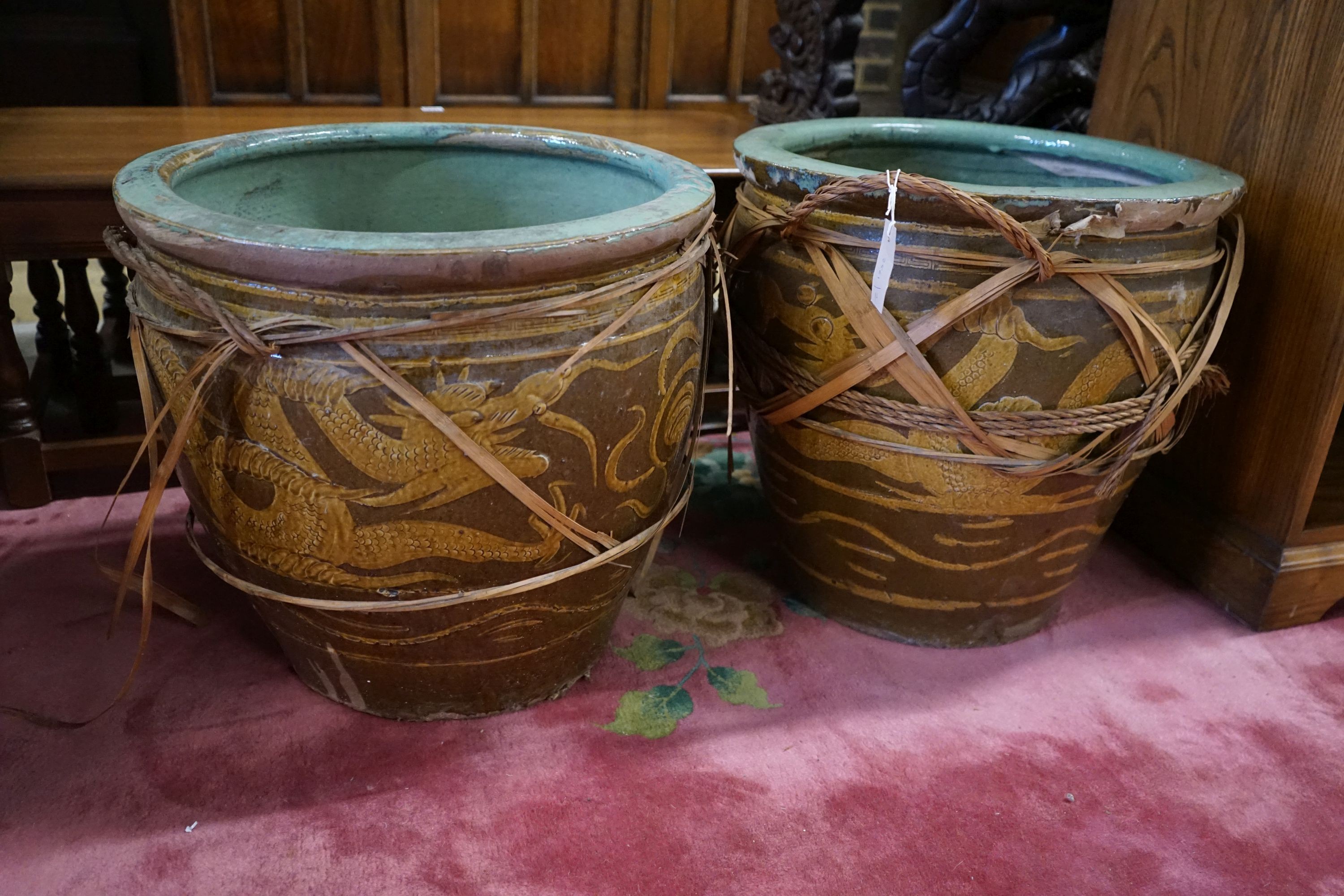 A pair of Chinese glazed earthenware dragon planters, diameter 50cm, height 47cm